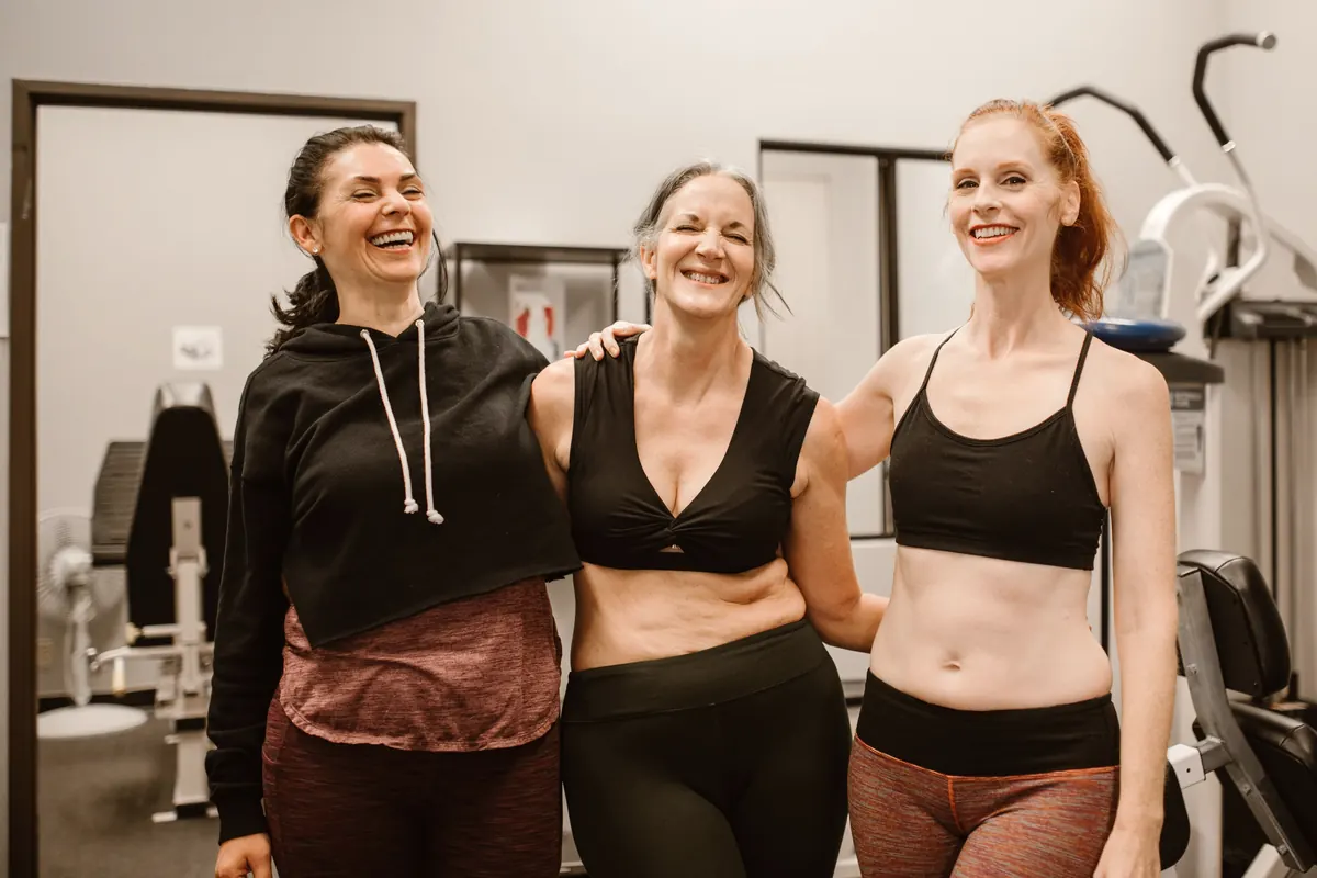 Three members laugh together after training